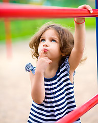 Image showing Cute little girl is playing in playground