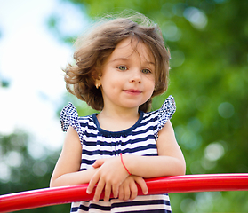 Image showing Cute little girl is playing in playground