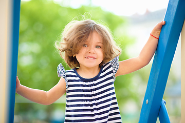 Image showing Cute little girl is playing in playground