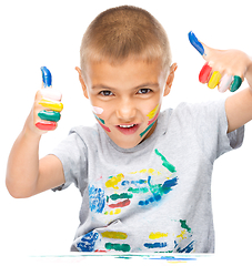 Image showing Portrait of a cute boy playing with paints