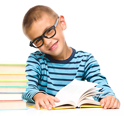 Image showing Little boy is reading a book