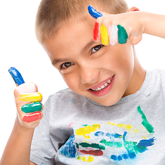 Image showing Portrait of a cute boy playing with paints