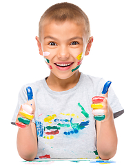 Image showing Portrait of a cute boy playing with paints