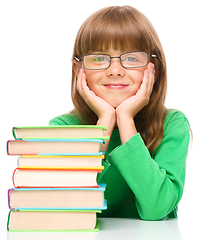 Image showing Little girl is reading a book