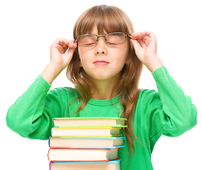 Image showing Little girl is reading a book