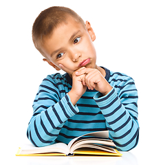 Image showing Little boy is tired to read his book