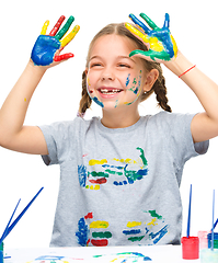 Image showing Portrait of a cute girl playing with paints