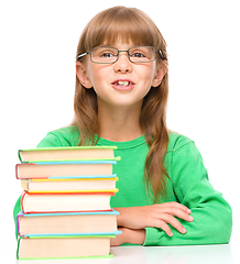 Image showing Little girl is reading a book