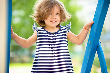 Image showing Cute little girl is playing in playground