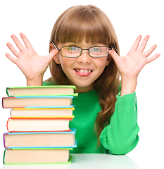 Image showing Little girl is reading a book