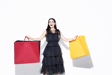 Image showing Young woman in dress shopping on white background