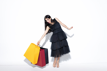 Image showing Young woman in dress shopping on white background