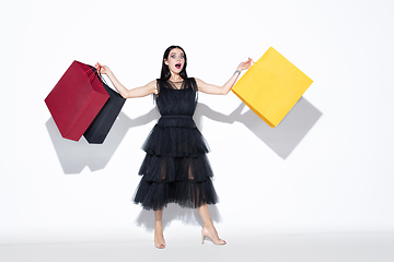 Image showing Young woman in dress shopping on white background