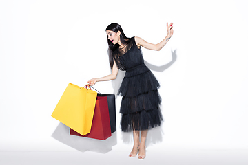 Image showing Young woman in dress shopping on white background