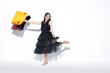 Image showing Young woman in dress shopping on white background