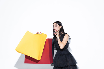 Image showing Young woman in dress shopping on white background