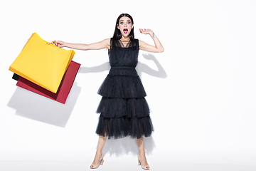 Image showing Young woman in dress shopping on white background