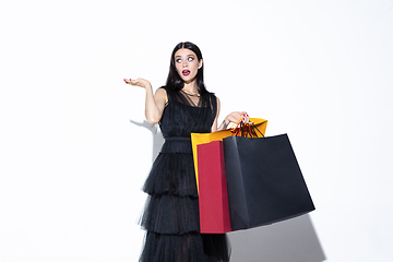 Image showing Young woman in dress shopping on white background