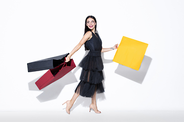 Image showing Young woman in dress shopping on white background