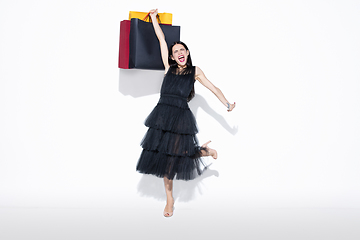 Image showing Young woman in dress shopping on white background