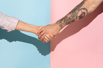 Image showing Closeup shot of human holding hands isolated on yellow studio background.