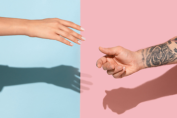 Image showing Closeup shot of human holding hands isolated on yellow studio background.