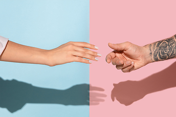 Image showing Closeup shot of human holding hands isolated on yellow studio background.