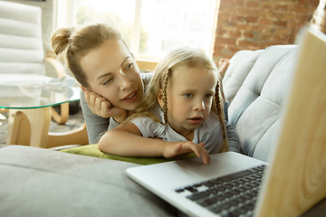 Image showing Teacher and little girl, or mom and daughter. Homeschooling concept