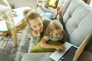 Image showing Teacher and little girl, or mom and daughter. Homeschooling concept