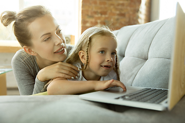 Image showing Teacher and little girl, or mom and daughter. Homeschooling concept