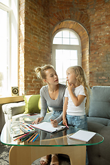 Image showing Teacher and little girl, or mom and daughter. Homeschooling concept