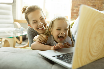 Image showing Teacher and little girl, or mom and daughter. Homeschooling concept