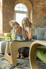 Image showing Teacher and little girl, or mom and daughter. Homeschooling concept