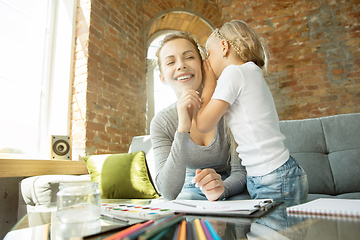 Image showing Teacher and little girl, or mom and daughter. Homeschooling concept