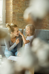 Image showing Teacher and little girl, or mom and daughter. Homeschooling concept