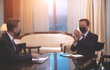 Image showing business people wearing crona virus protection face mask on meeting