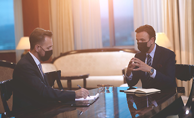 Image showing business people wearing crona virus protection face mask on meeting