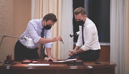 Image showing business people wearing crona virus protection face mask on meeting