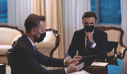 Image showing business people wearing crona virus protection face mask on meeting