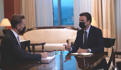 Image showing business people wearing crona virus protection face mask on meeting