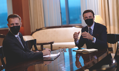 Image showing business people wearing crona virus protection face mask on meeting