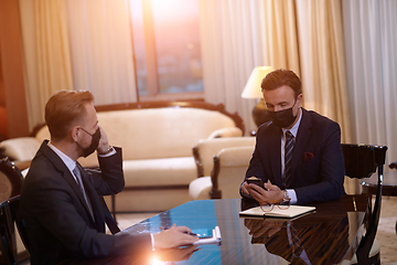 Image showing business people wearing crona virus protection face mask on meeting