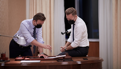 Image showing business people wearing crona virus protection face mask on meeting