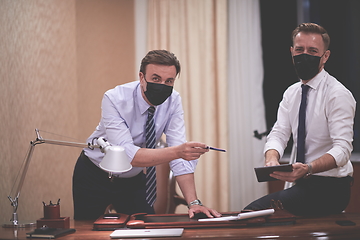 Image showing business people wearing crona virus protection face mask on meeting