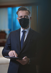 Image showing business man wearing protective face mask at office