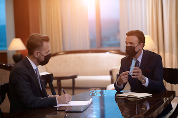 Image showing business people wearing crona virus protection face mask on meeting