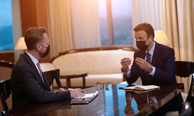 Image showing business people wearing crona virus protection face mask on meeting