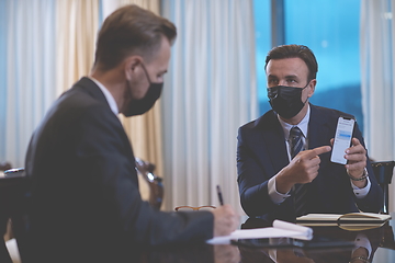 Image showing business people wearing crona virus protection face mask on meeting