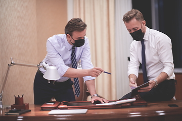 Image showing business people wearing crona virus protection face mask on meeting