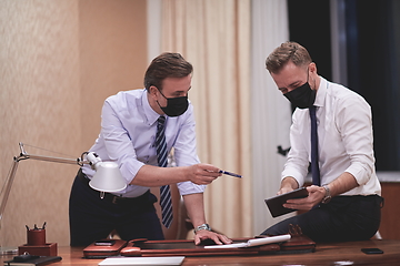 Image showing business people wearing crona virus protection face mask on meeting